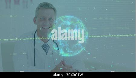 Smiling mature doctor using holographic globe at desk in clinic, with stethoscope and data overlay Stock Photo