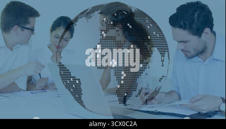 Digital mosaic globe overlay floating in office conference room, with laptop and printed charts Stock Photo