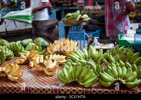 Fresh bananas and tropical fruits displayed at Victoria Market in Seychelles, showcasing colorful produce, local trade, and island lifestyle. Stock Photo