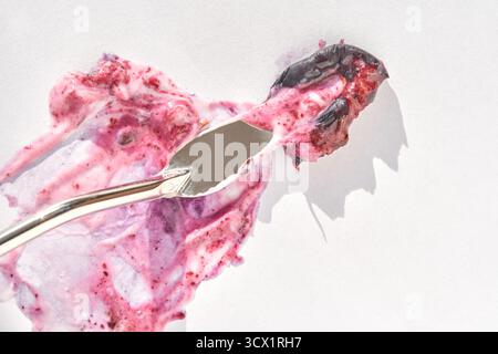 Abstract textured artwork created with palette knife and purple pigments on white canvas. Stock Photo
