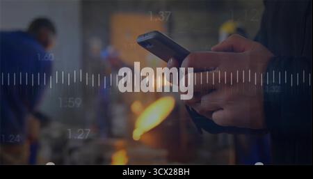 Holding male technician operating smartphone in workshop, furnace flame and metrics, copy space Stock Photo