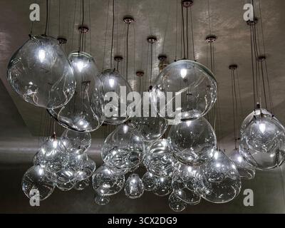 A whole lot of glass lights hanging from a ceiling Stock Photo