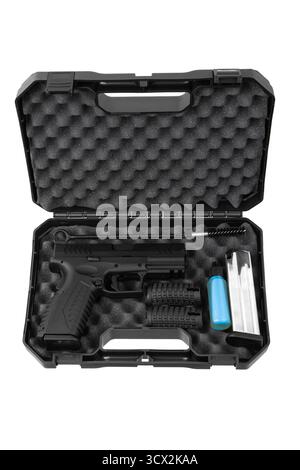 Open black foam-lined case containing a semi-automatic pistol, magazine, and accessories. Stock Photo