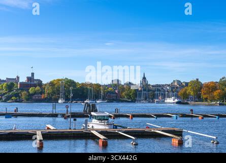 View of Kastellet and of Södermalm from Djurgården with autumn colorful trees, the baltic sea, blue sky. Stockholm, Sweden Stock Photo