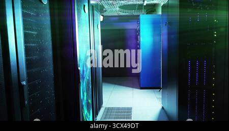 Central blue-lit server rack cabinet standing in data center corridor, with LED indicator lights Stock Photo