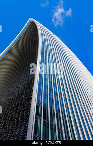 Detail View of The Fenchurch Building (The Walkie Talkie) From Ground Upwards from Corner in Sunlight with Clear Blue Sky and Single Wispy White Cloud Stock Photo