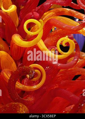 SEATTLE - APR 25, 2025 - Red and yellow swirling glass ribbons intertwine, creating a dynamic and captivating abstract composition, reminiscent of fla Stock Photo