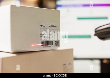 Close up of black person scanning awb tags after packaging operations in a distribution center, using a scanner to register barcode shipping labels for future order tracking. Storage room. Stock Photo