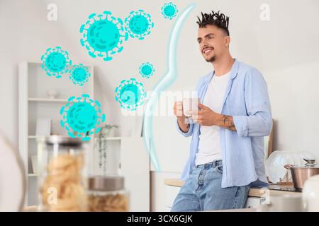 Young man drinking hot tea at home. Immunity concept Stock Photo