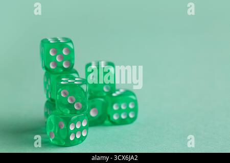 Green game dices on turquoise background Stock Photo