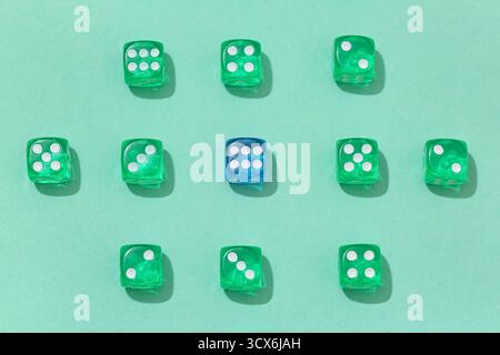 Green and blue game dices on turquoise background Stock Photo