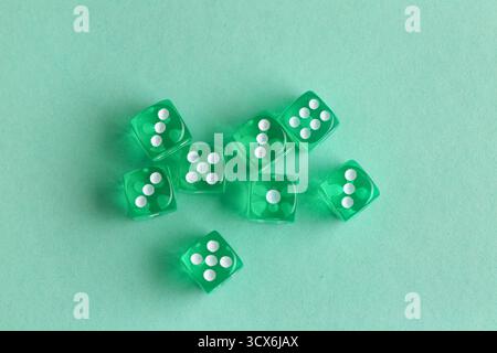 Green game dices on turquoise background Stock Photo