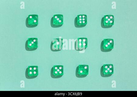 Green game dices on turquoise background Stock Photo