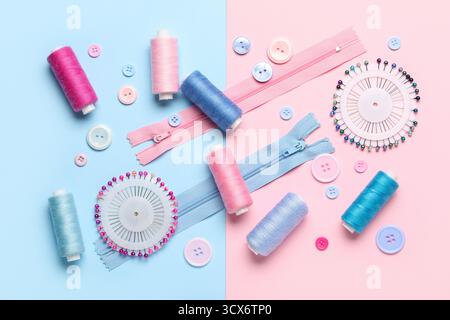 Composition with thread spools, zippers, ball pins and buttons on color background Stock Photo