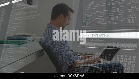 Working developer at office desk typing code on laptop with code overlay graphics, copy space Stock Photo