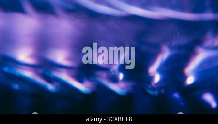 Blur radiant reflection. Abstract flare. Gleam purple blue color cold optical glisten texture on shiny luminous bokeh light art background. Stock Photo
