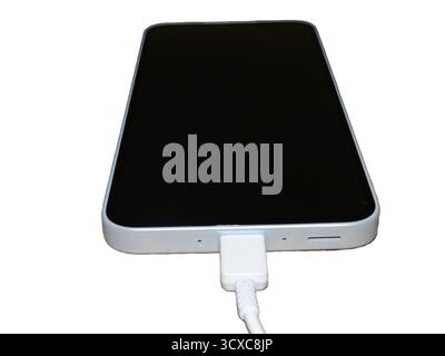 Smartphone isolated on white background. A smartphone is charging Stock Photo