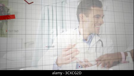 Smiling male doctor with stethoscope gesturing toward child patient in clinic, with chart overlays Stock Photo