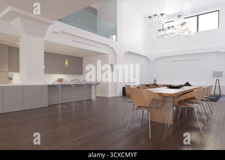 A wide shot of a modern, open-plan loft apartment with a dining area and kitchen. The space features high ceilings, a mezzanine, wooden floors, and co Stock Photo