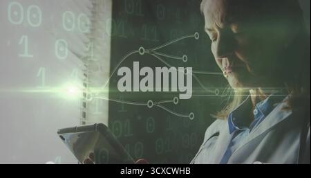 Standing at blinds, senior scientist in lab coat using tablet displaying binary code, copy space Stock Photo