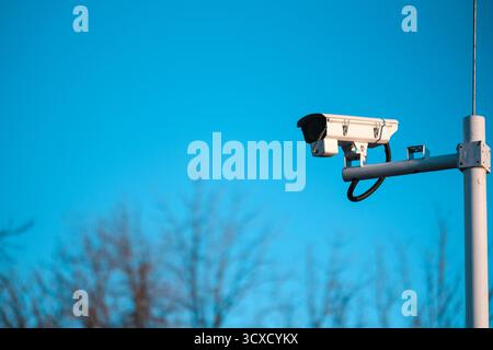 CCTV Camera on Blue Sky Background Stock Photo