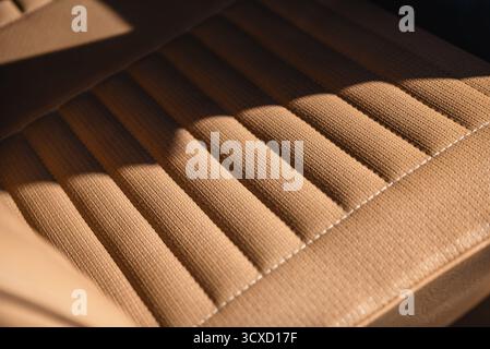 Close-up view of car vinyl seat - beige-brown basket weave vinyl in 1960s car. Stock Photo