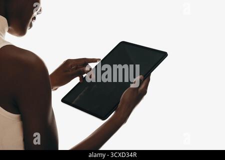 A person interacts with a modern tablet device, showcasing contemporary technology and connectivity. Stock Photo