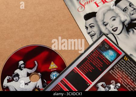 'Some Like It Hot' DVD disc with cover featuring movie description, isolated on light blank background, top angle shot Stock Photo