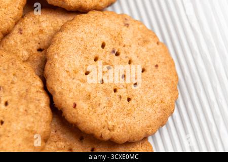 Round holey shortbread cookies on white wrapping paper Stock Photo