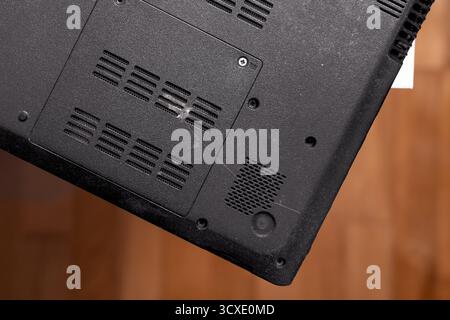 Back side of old black laptop on table close up. Top view Stock Photo