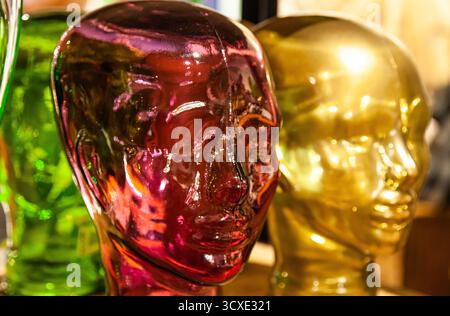 The form of glass, transparent heads of people in yellow, red and green colors, close-up Stock Photo