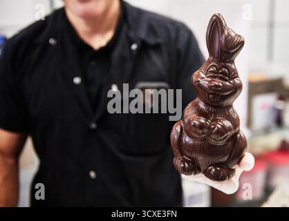 man holding a chocolate Easter bunny Stock Photo