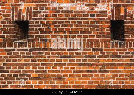 Texture of a medieval wall made from orange bricks Stock Photo
