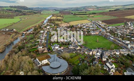 Aerial view of a rural village surrounded by vibrant green rice paddies ...
