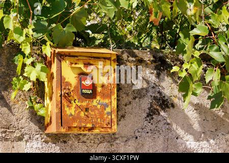 Old vintage yellow mail box in Bulgaria Stock Photo