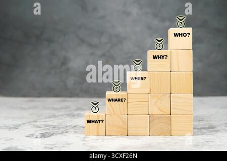 Wooden cubes arranged as staircase with question words What, Where, When, Why, and Who. Concept of analysis, strategy, problem solving. Stock Photo
