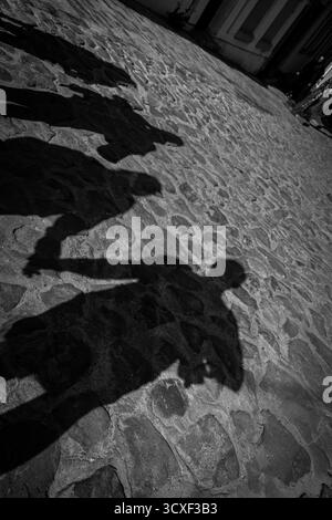 Shadows of people on the asphalt. Stock Photo