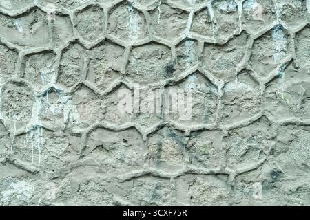 Traditional city wall from Leh, Ladakh featuring an plaster surface with unique honeycomb-like geometric pattern, as background.  Stock Photo
