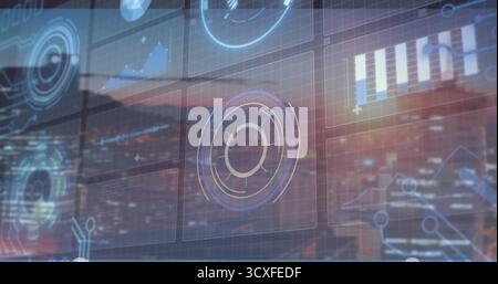Displaying UI with circular HUD and charts over window showing dusk city skyline in control room Stock Photo