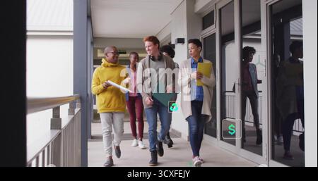 Group of five adults walking in covered campus corridor, with folders notebooks headphones backpack Stock Photo
