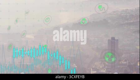 Displaying digital graph overlay on hazy city valley, with line graph bar plot and energy icons Stock Photo