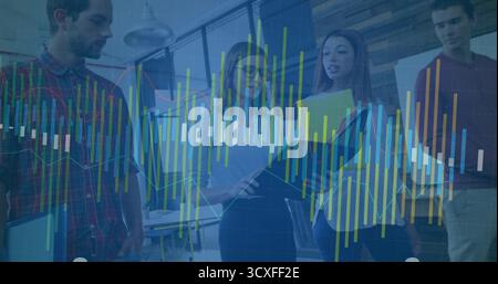 Reviewing data, four coworkers using laptop, clipboard, documents and multicolor overlay in office Stock Photo