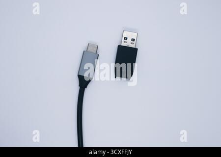 A close-up of a USB-C cable connected to a USB-A connector. Stock Photo