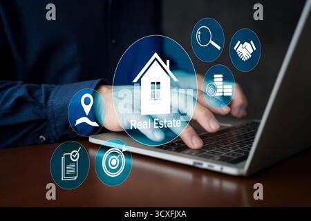 Businessman using laptop with real estate icons representing property investment, housing, and marketing strategy. Modern technology concept for onlin Stock Photo