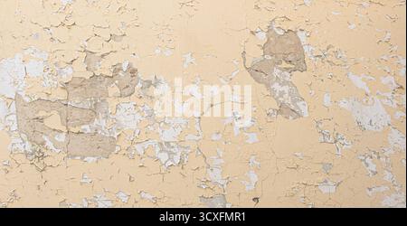 Grunge wall surface with aging paint flakes and distressed plaster Stock Photo