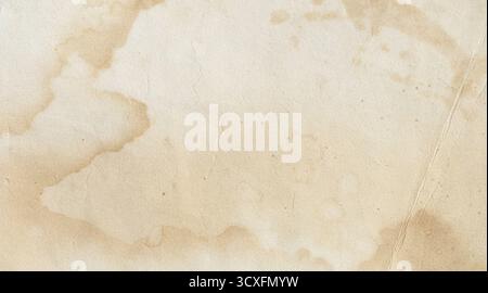 Vintage paper showing abstract brown stains and a creased, textured surface, providing an old background Stock Photo