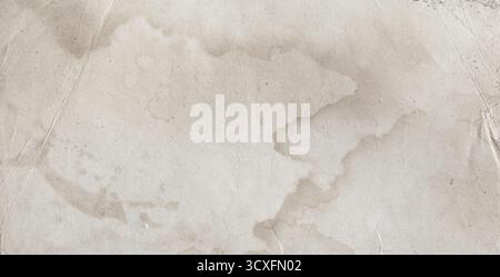 Vintage paper background presenting aged surface with water damage and creases Stock Photo