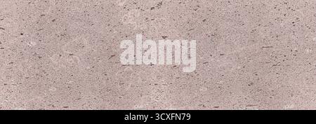 Pink granite rock featuring a coarse, speckled, and porous surface texture Stock Photo