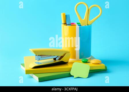 Stapler and other stationery on light blue background Stock Photo