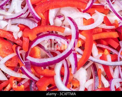 Colorful mix of sliced red onions and bell peppers—fresh, vibrant, and perfect for food visuals. Stock Photo